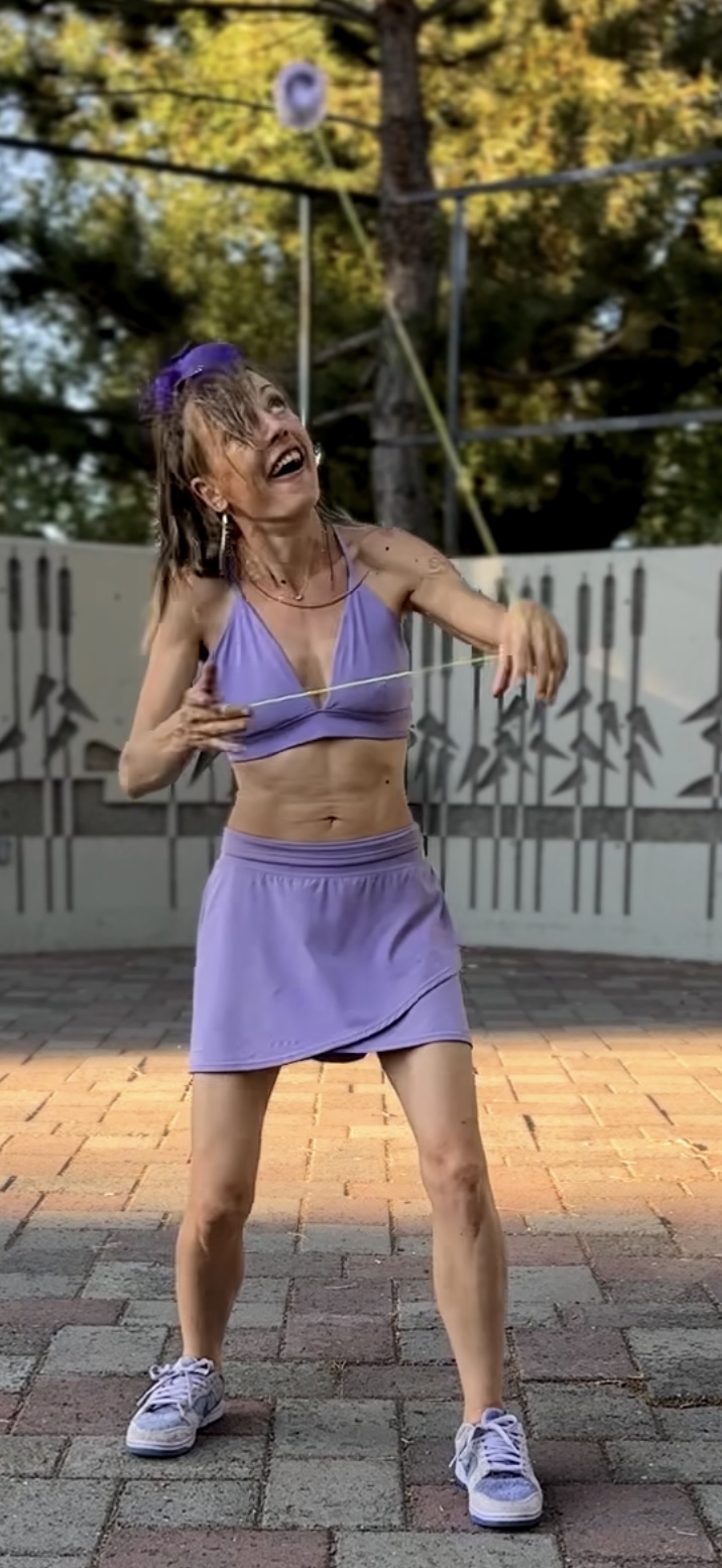 Professor Joy demonstrating a yo-yo trick during a live performance